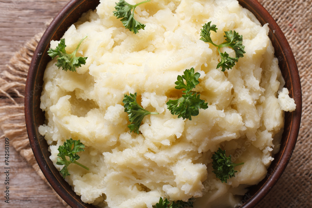 mashed potatoes with parsley in a bowl macro top view mashed potatoes with parsley in a bowl macro top view