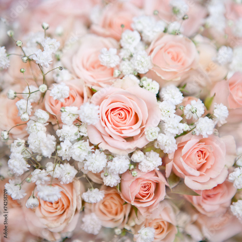 soft pink wedding bouquet with rose bush and little white flower