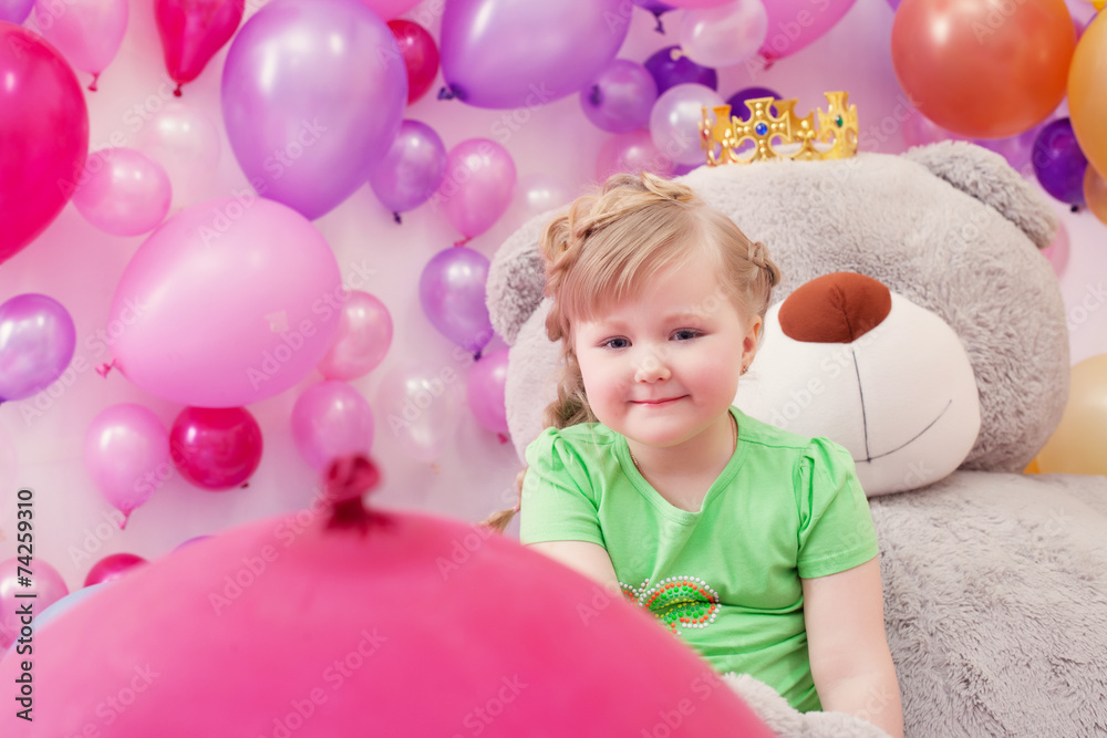 Neat little girl posing in studio with balloons Neat little girl posing in studio with balloons