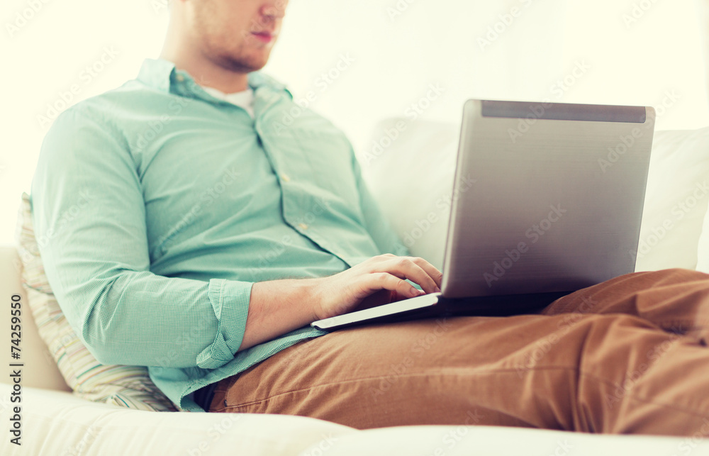 close up of man working with laptop at home