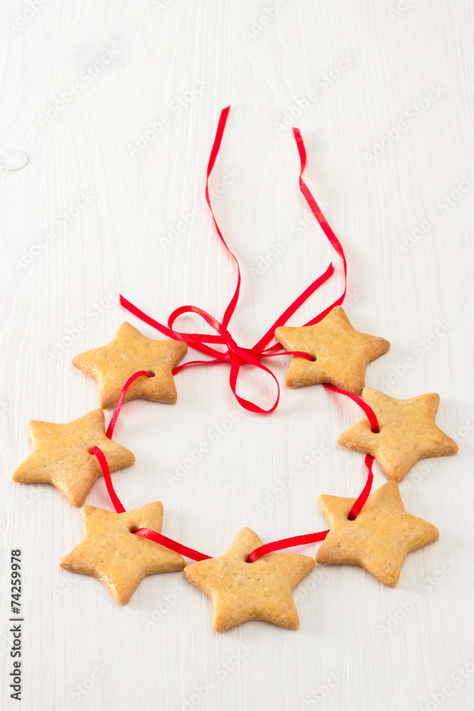 Christmas stars cookies on white wooden background