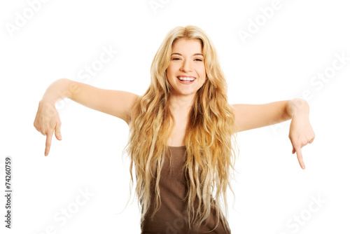 Happy student woman pointing down