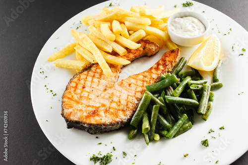 grilled salmon steakk with french fries photo