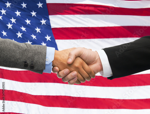 close up of handshake over american flag