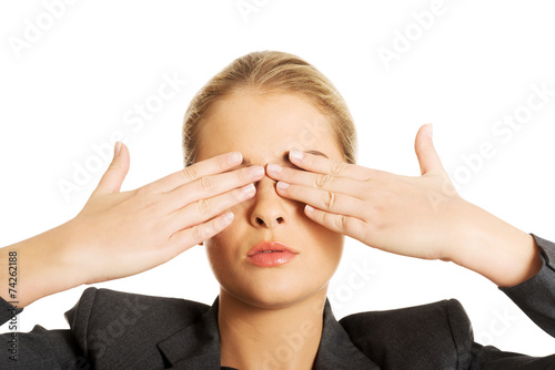 Woman covering her face with both hands