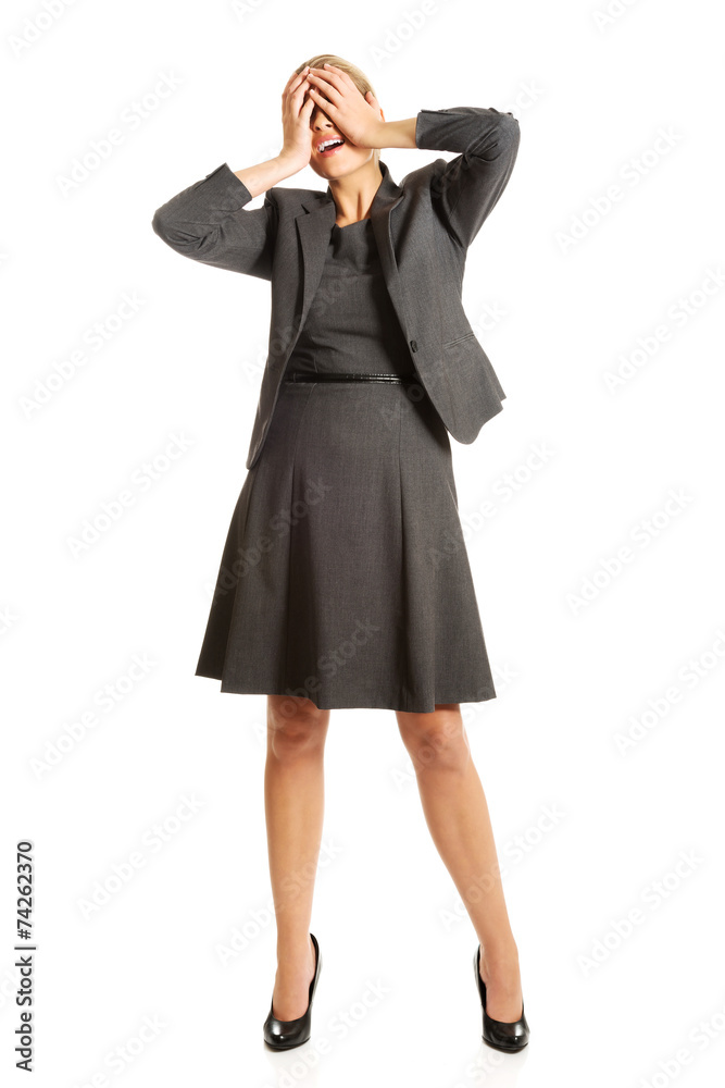 Woman covering her face to camouflage Woman covering her face to camouflage