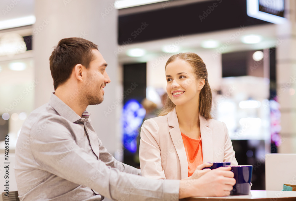 Fototapeta premium happy couple with shopping bags drinking coffee