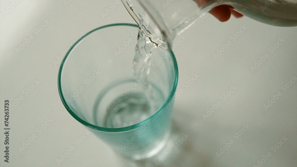 Pouring glass of water in slow motion Pouring glass of water in slow motion