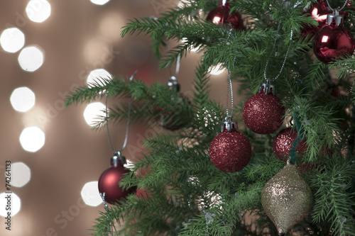 Valokuva Christmas Ornament with Lighted Tree in Background
