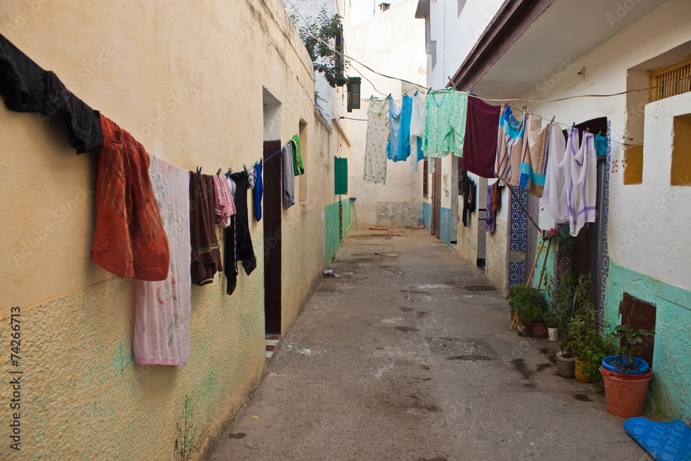 Narrow street with laundry in Asilah Narrow street with laundry in Asilah
