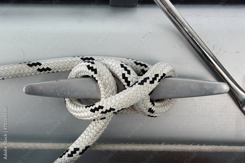 Obraz premium metal cleat with figure eight tied rope on boat or sail yacht