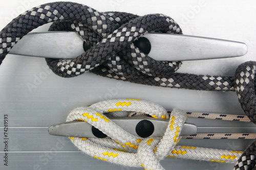 metal cleat with figure eight tied rope on boat or sail yacht	