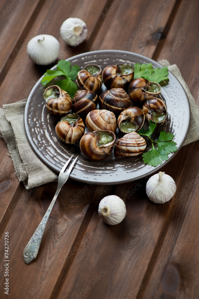 Escargots de Bourgogne, rustic brown wooden background Escargots de Bourgogne, rustic brown wooden background