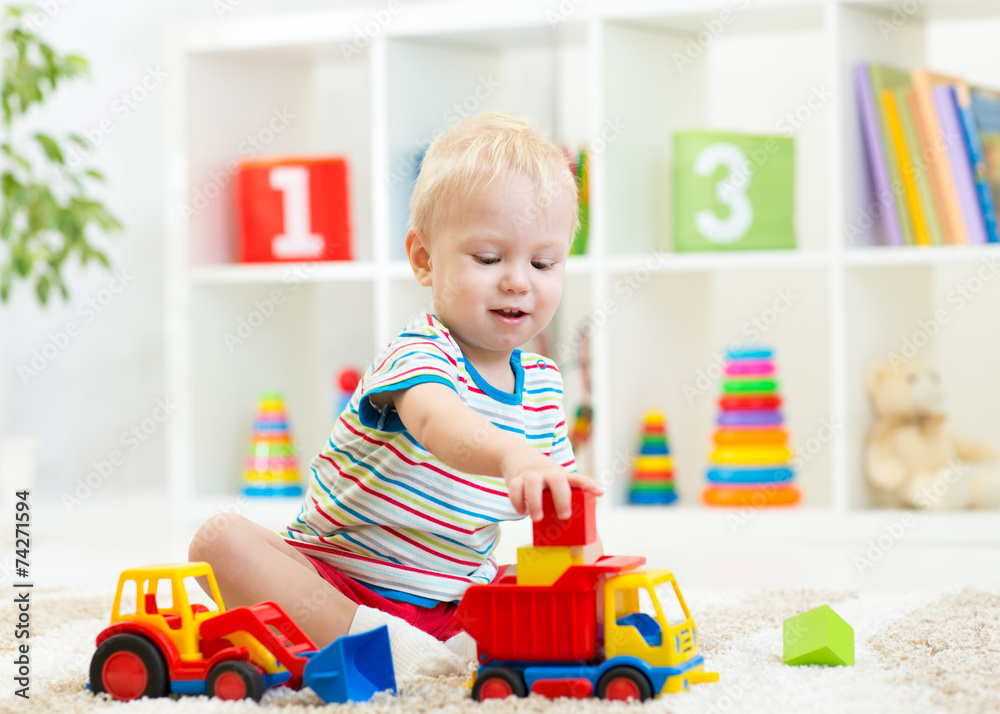 little boy toddler playing with toy car little boy toddler playing with toy car