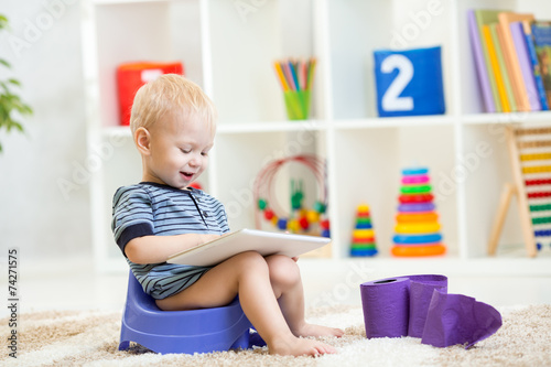 kid sitting on chamber pot ...