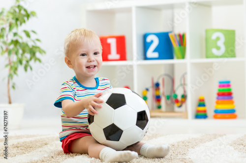 kid boy with football  indoor