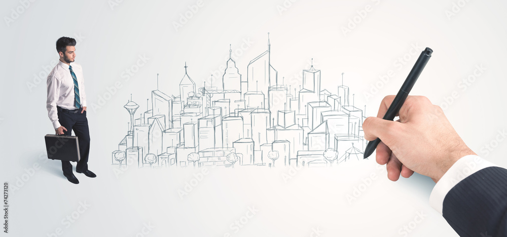 Businessman looking at hand drawn city on wall Businessman looking at hand drawn city on wall