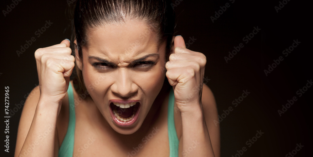portrait of beautiful angry woman on a dark background portrait of beautiful angry woman on a dark background