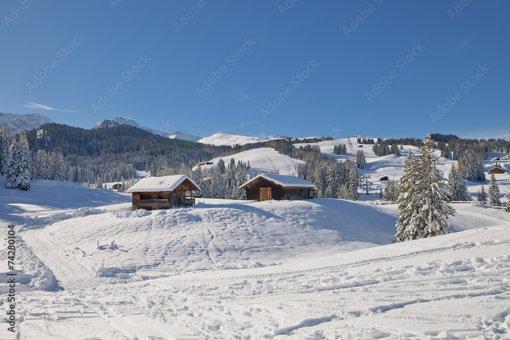 Typical wooden chalet in the Dolomites mountain in winter