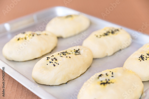 rows of buns in a bakery © YAOWARAT