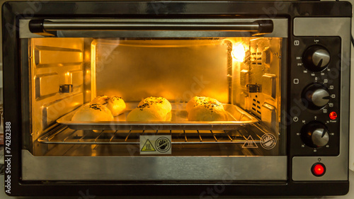 Baked Bun In Front Of Microwave Oven