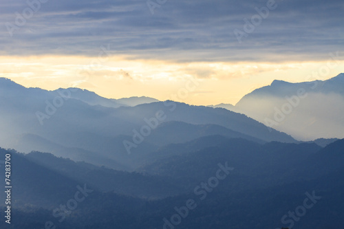 Fototapeta Naklejka Na Ścianę i Meble -   clouds with silhouetted mountians