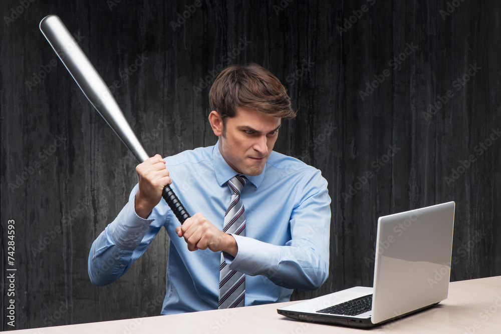 Angry businessman with laptop and bat Angry businessman with laptop and bat