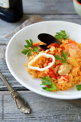 Risotto with meat mussels and rice on a bowl