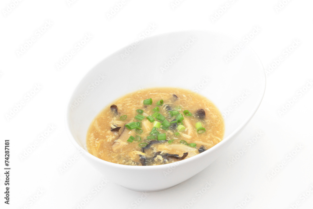 A bowl of Hot and Sour Soup on a white background
