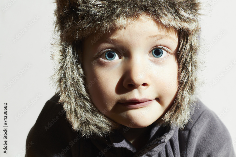 Funny child in fur Hat.winter style.little boy.children emotion Funny child in fur Hat.winter style.little boy.children emotion