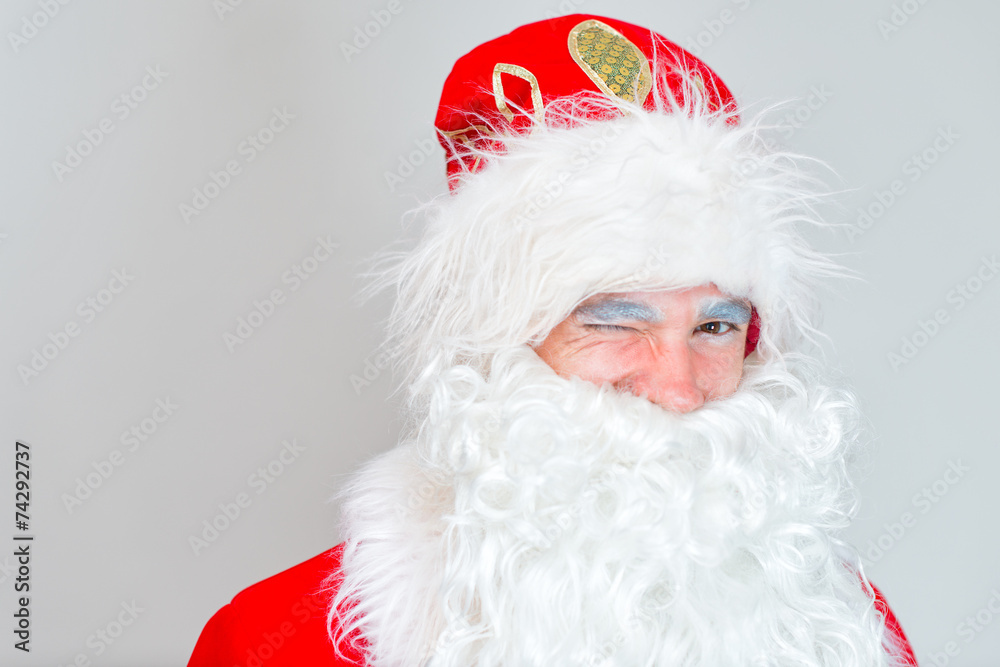 Portrait of winking Santa Claus. Place for your text.