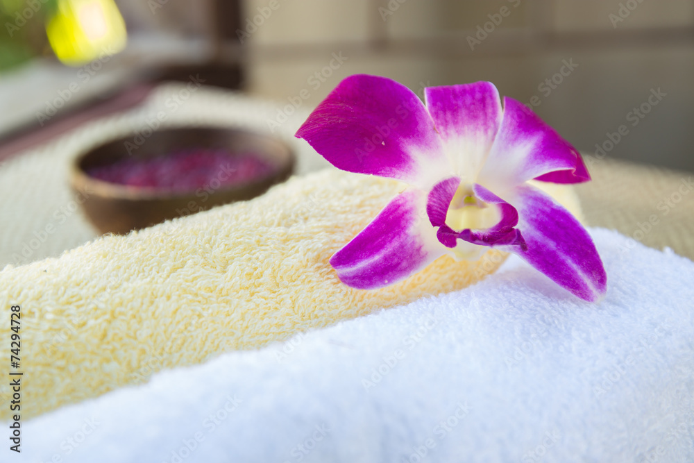 Spa and wellness setting with flowers and towel Spa and wellness setting with flowers and towel