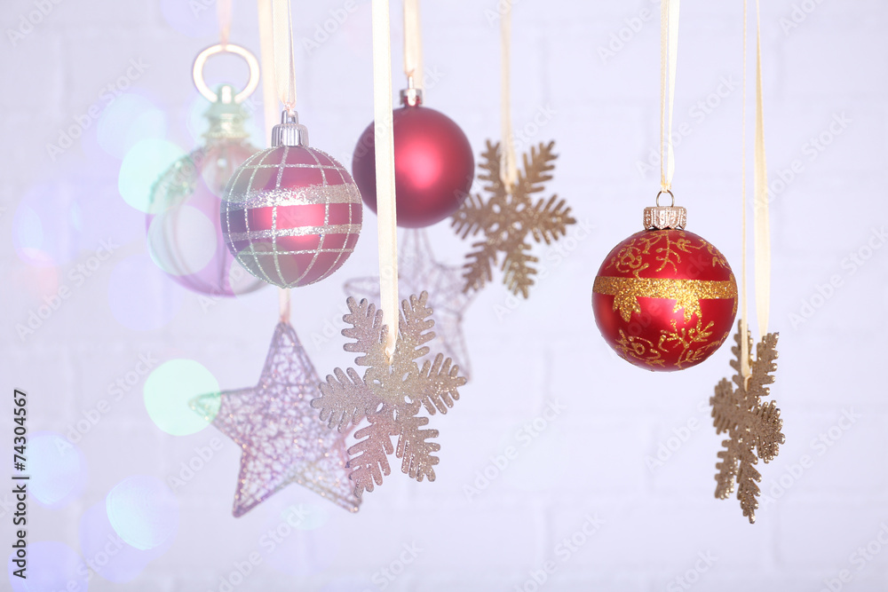 Christmas decorations hanging on festive background Christmas decorations hanging on festive background