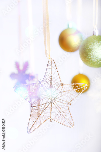 Christmas decorations hanging on festive background