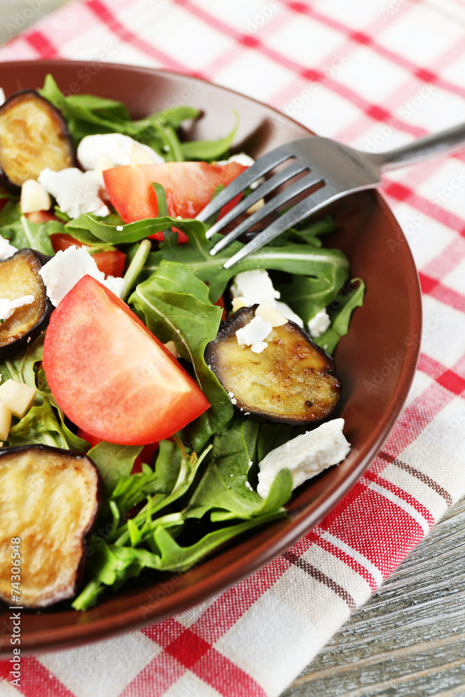 Eggplant salad with tomatoes, arugula and feta cheese,