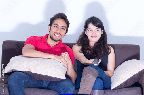 young attractive couple watching movie at home