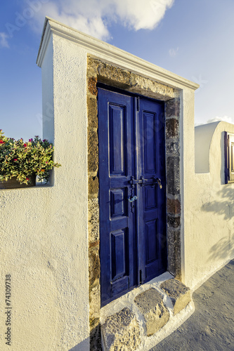 Blue colored wooden door of a house in Santorini Island, Greece