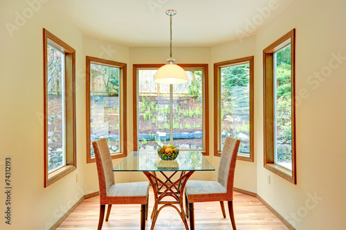 Cozy dinig area by the round wall with windows. photo