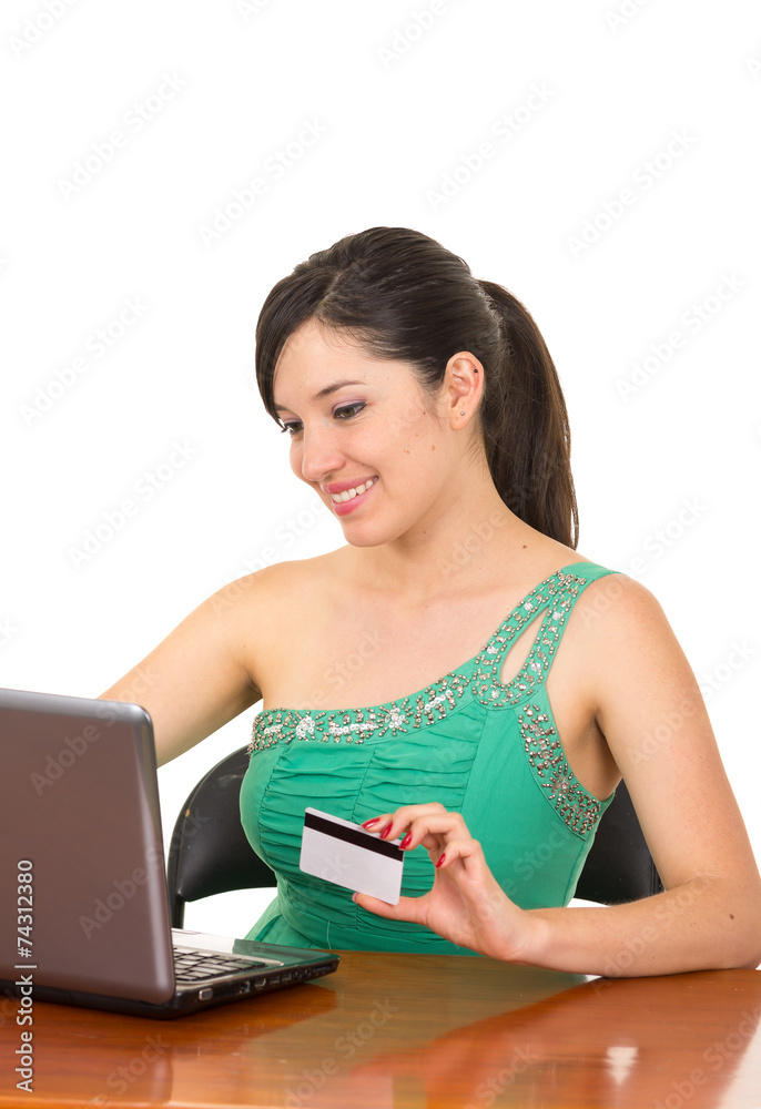 pretty young happy girl sitting in front of her laptop buying