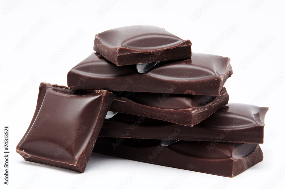 Dark chocolate bars stack with crumbs isolated Dark chocolate bars stack with crumbs isolated