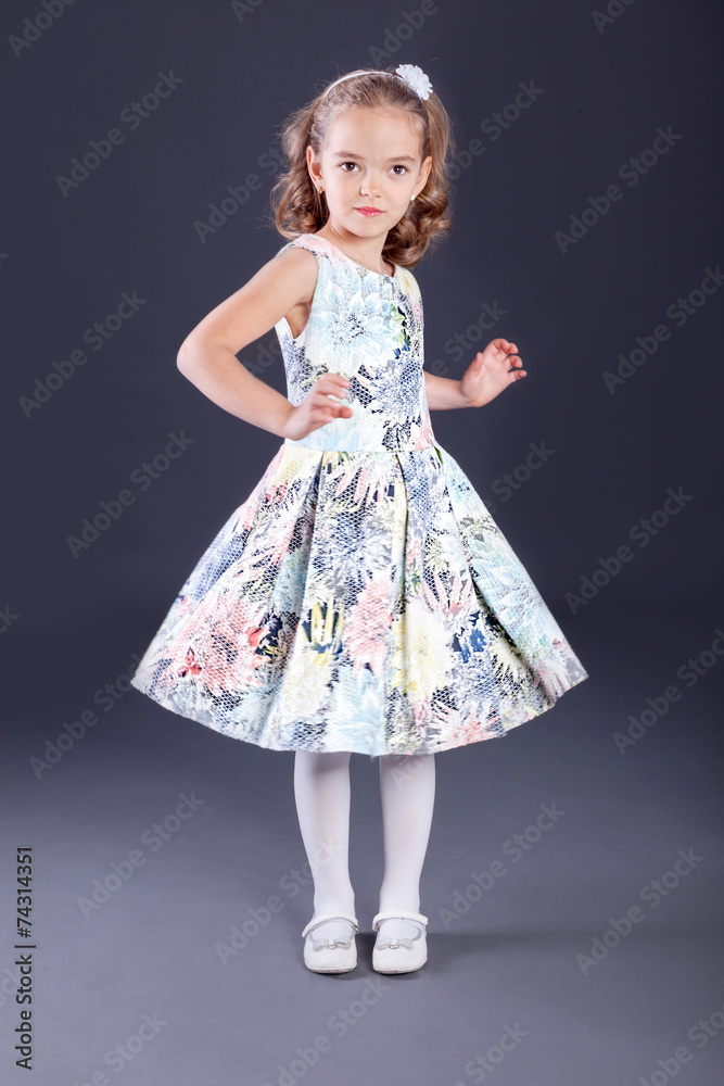  Portrait of little girl in luxurious dress. Fashion photo