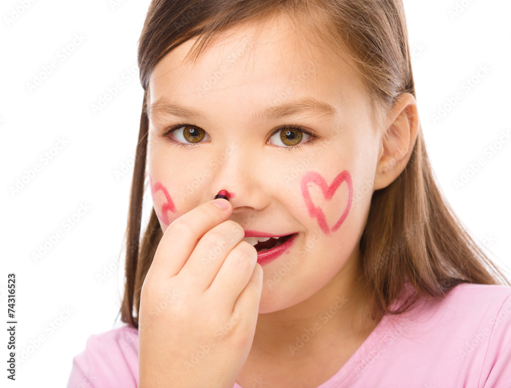 Little girl is applying lipstick on her nose Little girl is applying lipstick on her nose