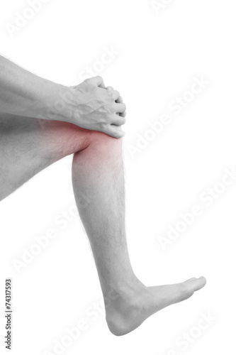 Man holding injured knee. © Eskymaks