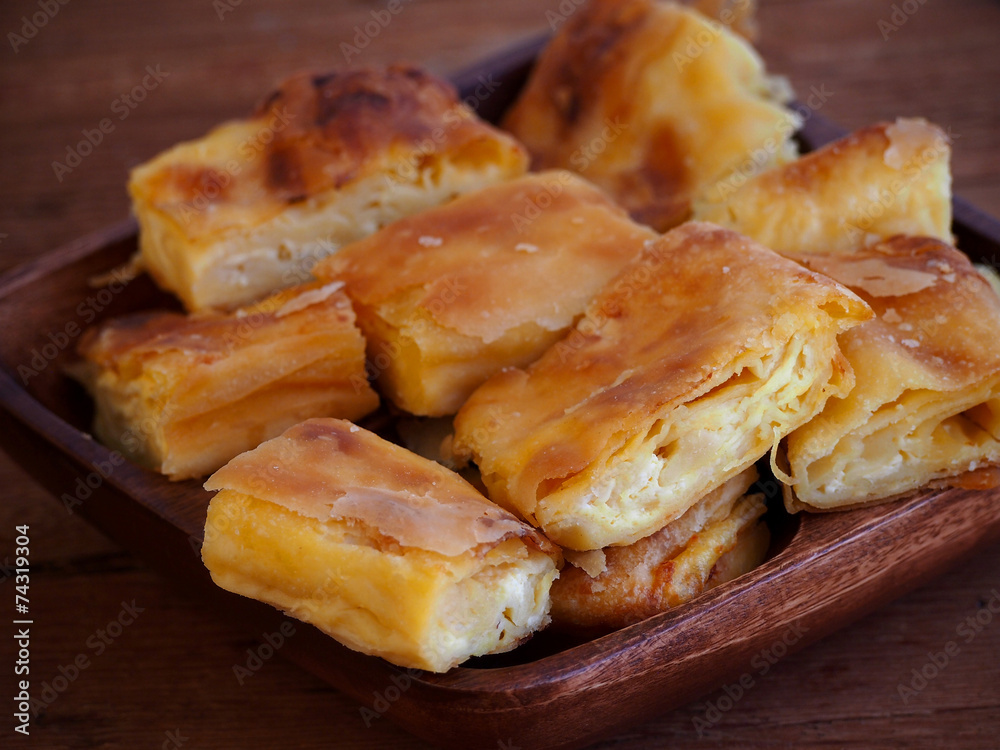 Homemade cheese strudel on wooden tray