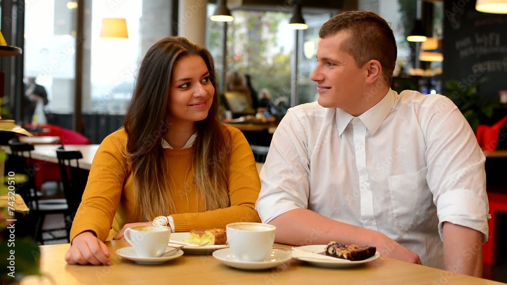 happy couple smiles in cafe (to camera) - coffee and cake happy couple smiles in cafe (to camera) - coffee and cake