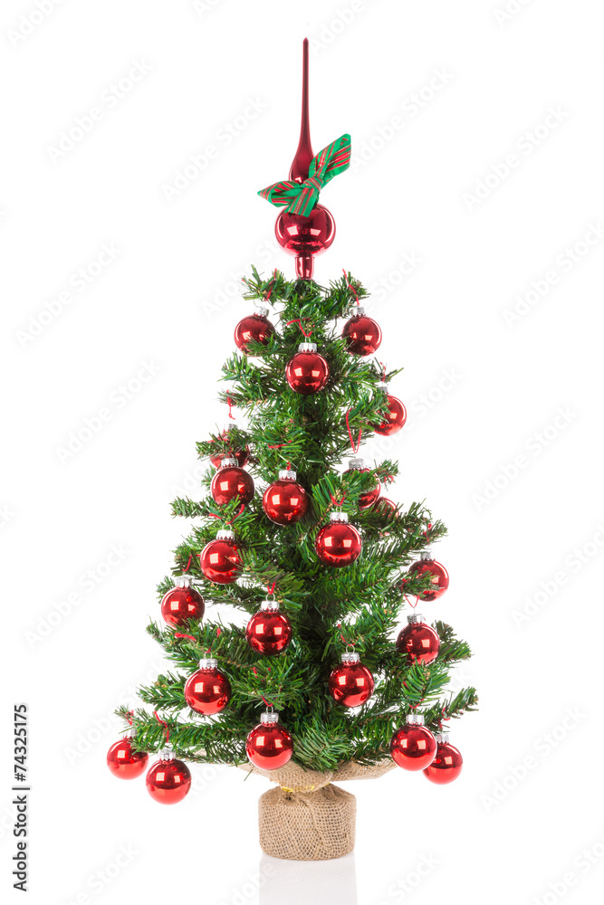 Decorated Christmas tree with peak balls over a white background
