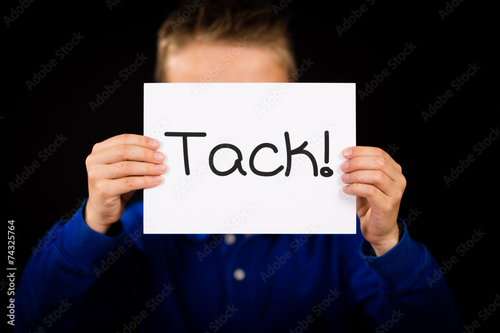 Child holding sign with Swedish word Tack - Thank You Child holding sign with Swedish word Tack - Thank You