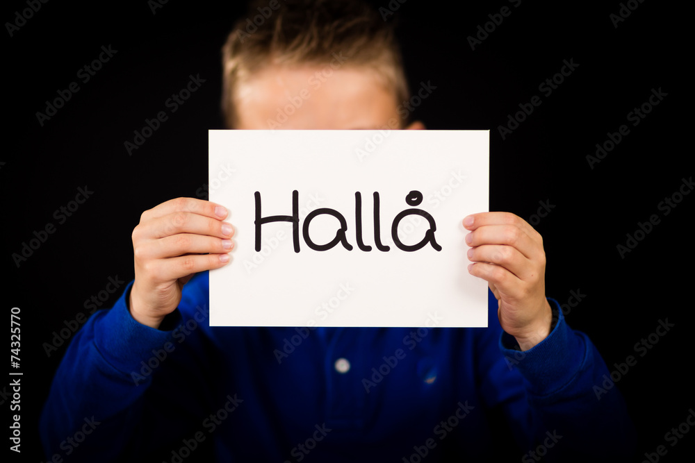 Child holding sign with Swedish word Halla - Hello Child holding sign with Swedish word Halla - Hello