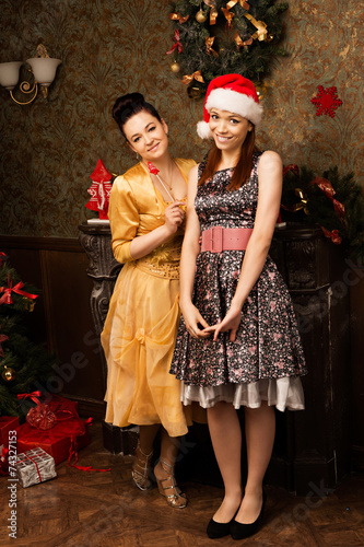 Portrait of two young woman posing at New Year eve.