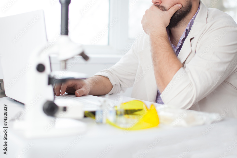 Young Doctor thinking during of using computer Young Doctor thinking during of using computer